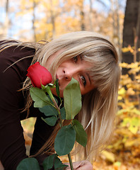 Image showing girl with rose in autumn park