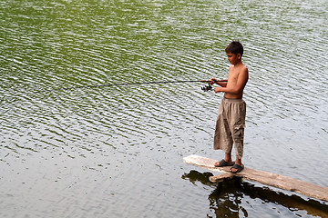 Image showing boy fishing with spinning on stage