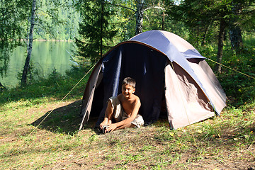 Image showing smiling boy near tent