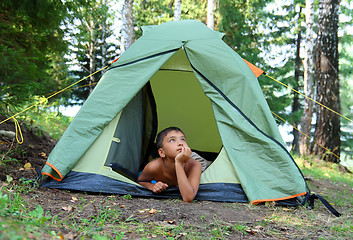 Image showing thoughtful boy in tent