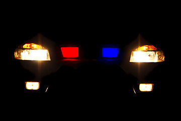 Image showing bright headlights of police car