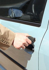 Image showing men hand with key open car door 