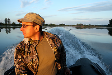 Image showing men on boat with motor