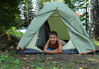 Image showing smiling boy in tent