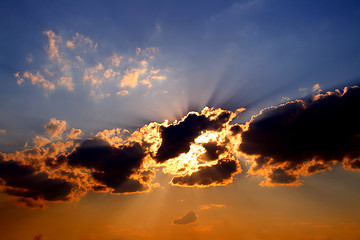 Image showing sun rays behind dark clouds in sky