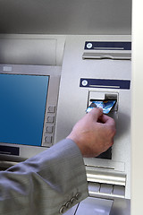 Image showing hand inserting card into cash dispense