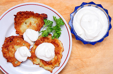 Image showing potato pancakes with sour cream