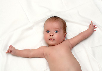 Image showing baby lying on white sheet