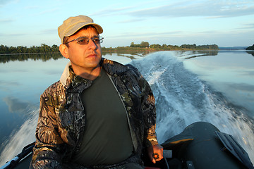 Image showing men on boat with motor