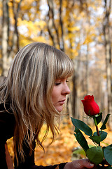 Image showing girl with rose in autumn park