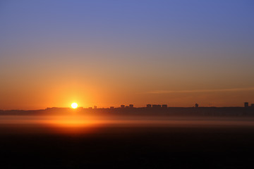 Image showing sunrise over far town