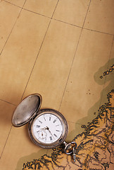 Image showing Old silver watch on ancient map