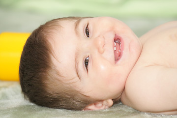 Image showing Baby laying down on rug