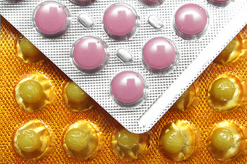 Image showing Pink and yellow pills in packs