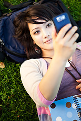 Image showing Mixed race student texting