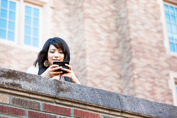 Image showing Mixed race student texting