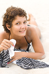 Image showing brunet woman lying on a sand