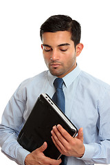 Image showing Businessman holding laptop computer