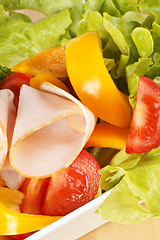 Image showing Close-up of a mixed salad with roast turkey