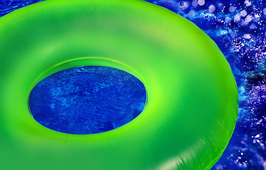 Image showing Green Inner Tube on Blue Pool Wate