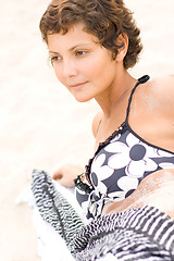 Image showing brunet woman lying on a sand