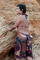 Image showing brunet woman in brow dress among rocks