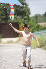 Image showing Boy running with kite