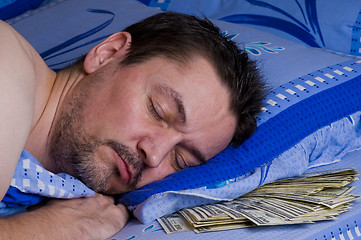 Image showing man with money under his pillow