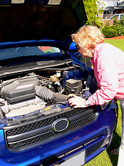 Image showing Lady with blue car                                 