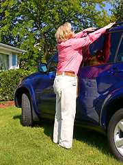 Image showing Lady with blue car                                         