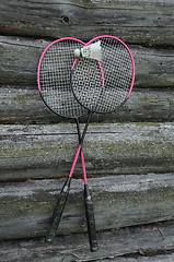 Image showing Badminton Rackets and Birdie on the Wooden Wall