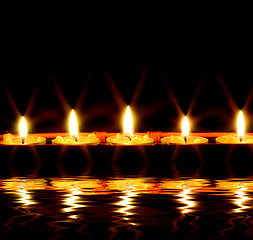 Image showing Candles by the water