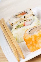 Image showing Sushi rolls and chopsticks