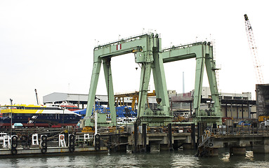 Image showing container vessel moored in the port, no trademarks visible 