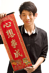 Image showing Young Asian man holding chinese lucky word fora chinese new year