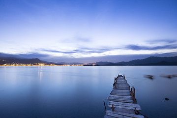 Image showing a romantic blue sunset with a jetty over a lake with an evening 