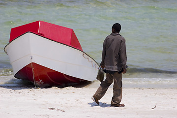 Image showing African man looking at boat