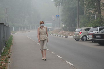 Image showing Woman Walking in Thick Smog