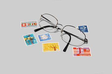 Image showing Collectible stamps with eyeglasses.