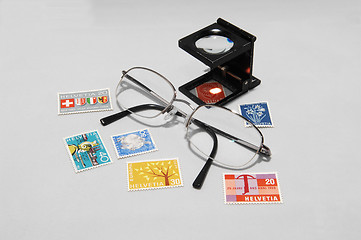 Image showing Collectible stamps with eyeglasses.