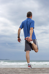 Image showing Runner doing stretching exercise