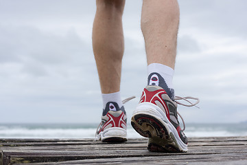 Image showing Feet of runner on a beach