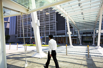 Image showing Businessman walking in modern building outdoor
