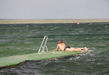 Image showing Boy laying down on pier