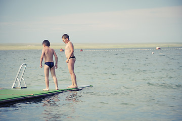 Image showing Boys on pier