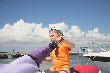 Image showing Boy driving water scooter 