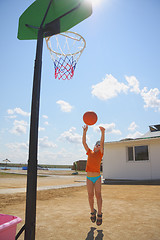 Image showing Boy throwing ball to basket
