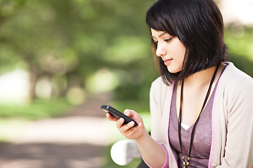 Image showing Mixed race student texting