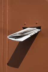 Image showing delivered newspaper on red door