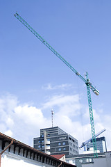 Image showing tower crane working on construction on blue sky